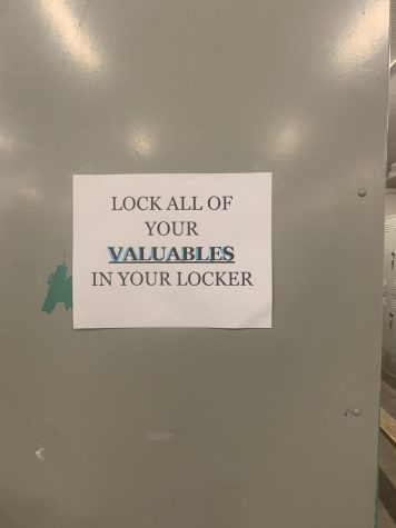Signs posted in the girls P.E. locker room warn students not to leave out valuables.