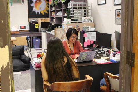 Humanities counselor Ms. Morales meets with students in her office.