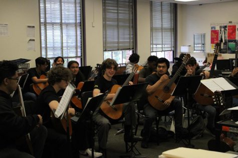 AMPA students participate in a guitar class.