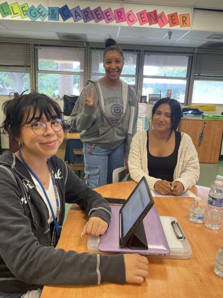 Lisset, Paulina, and Ms. Wilson help students after school.