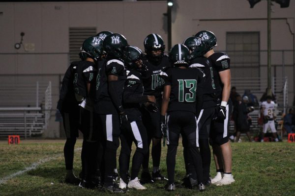 Hamiltons football team huddles together to confirm a play in Fridays homecoming game against Fairfax.