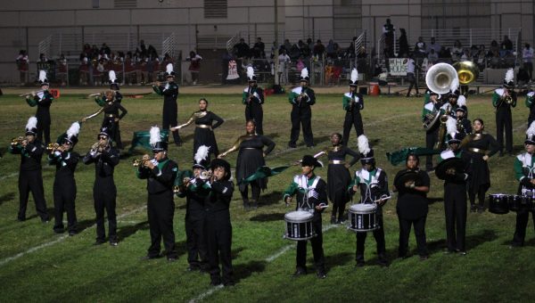 A half-time performance during the homecoming game features both the marching band and the color guard show.
