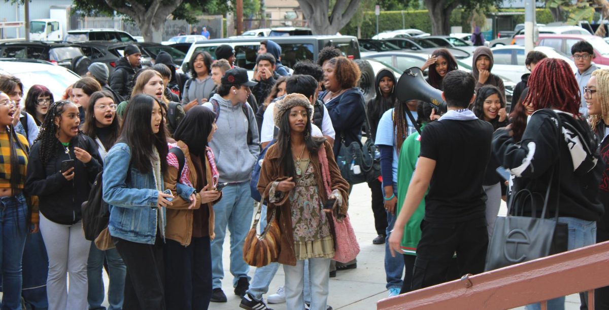 Students gather outside the front of the school Nov. 17 as protest leaders inform them of the protest’s purpose.