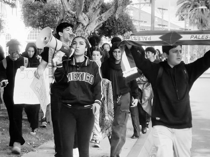 Henna Lopez-Spears leads Hamilton students outside of school in a walkout towards city hall to call for a ceasefire.
