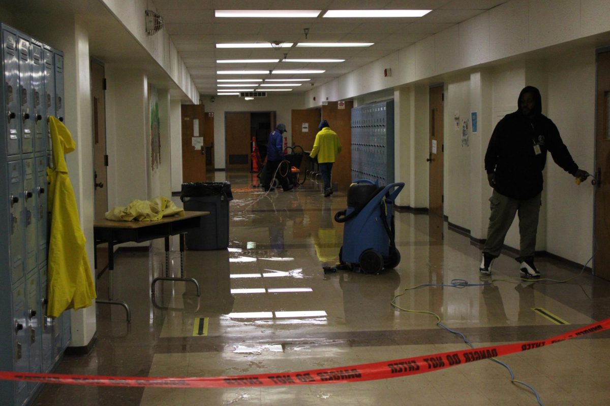 Staff clears water from the flooded basement of the lab building.