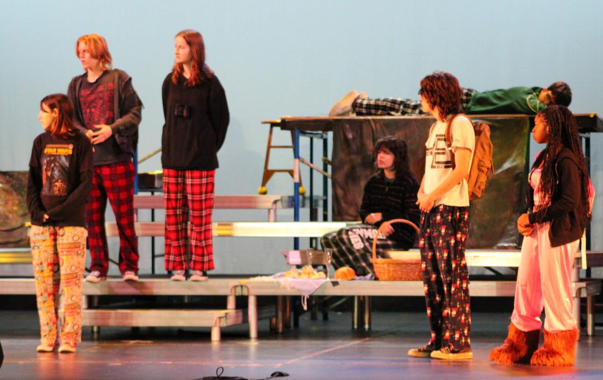 Members of the cast look off stage as they practice a scene A Midsummer Nights Dream