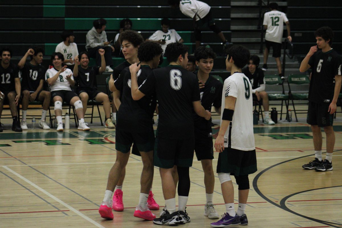 The Yankee boys volleyball team celebrates getting a point.