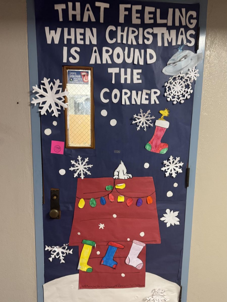 A Snoopy themed door integrates a trending Grinch meme for students to enjoy.