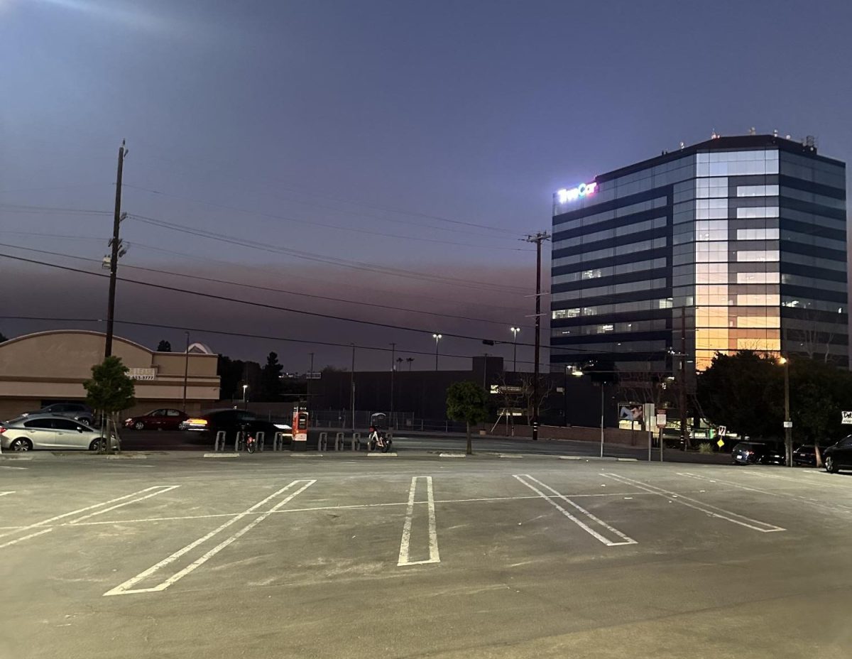 Smoke is seen from a distance in a parking lot at CVS.