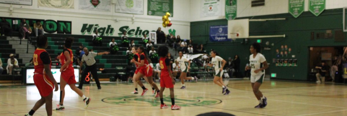 The varsity girls advance the ball up the court.