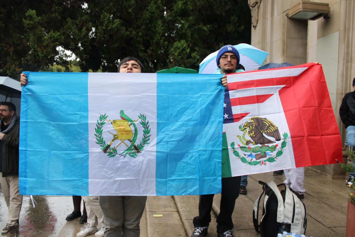 Students of different nationalities hold up the flags of their countries.