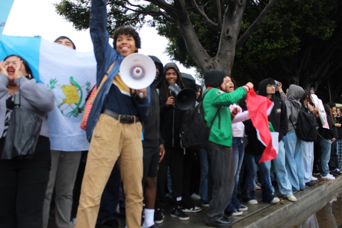 Jayland Sims leads students in a chant.