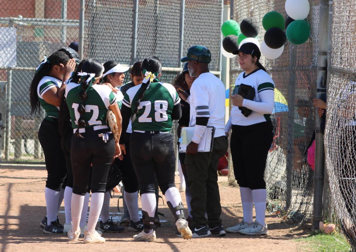 The Hami softball team huddles together right after they start their scoring streak.