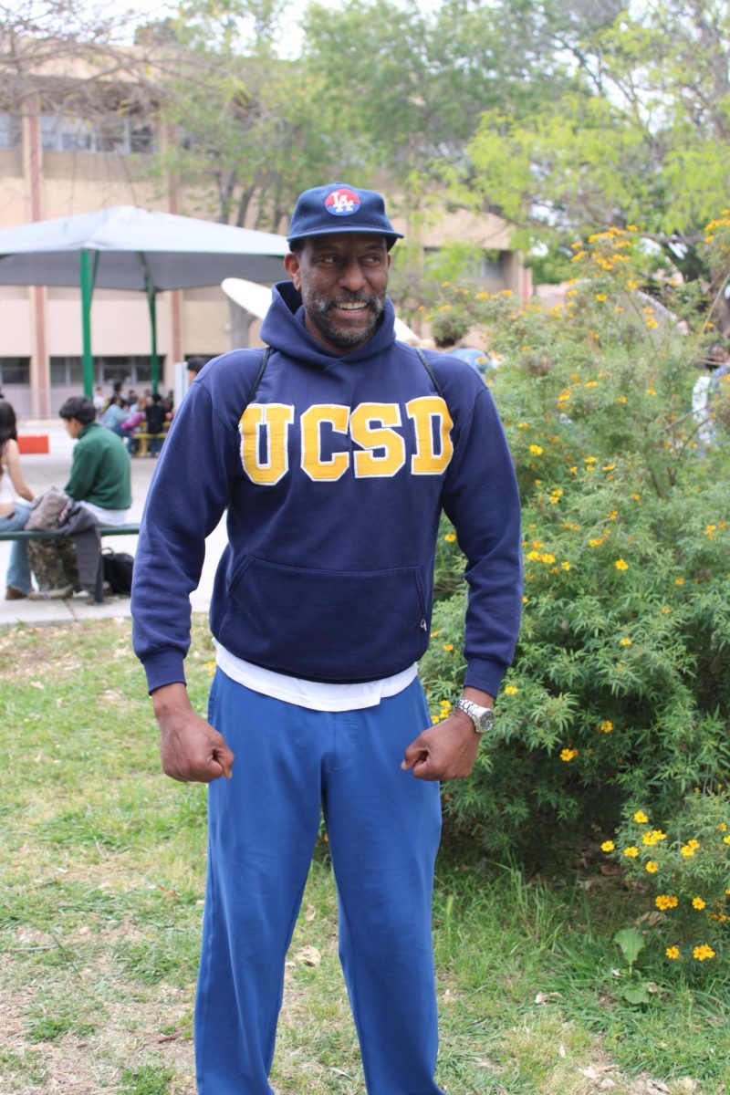 Chemistry teacher Mr. James reps his college in a hoodie borrowed from Ms. Pollock.