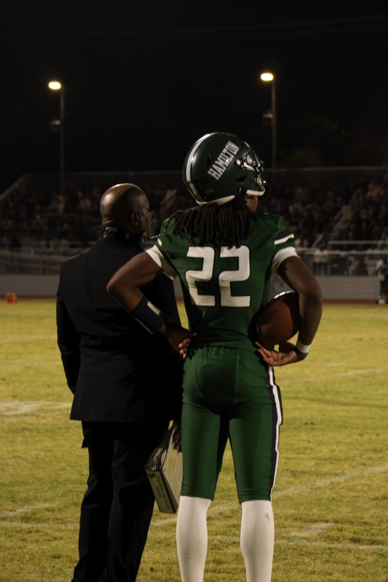 #22 Thaddeus Breaux standing alongside Coach Asante. 