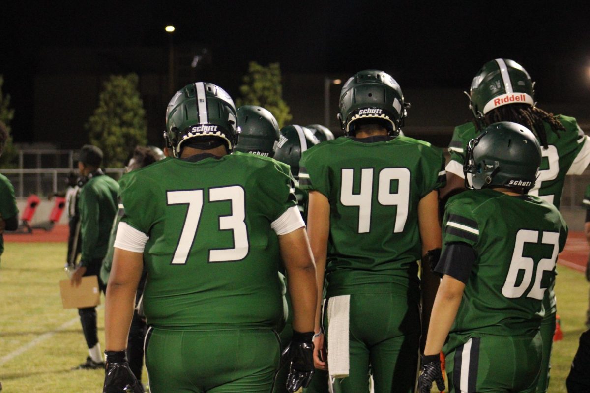 Players huddle on sidelines.