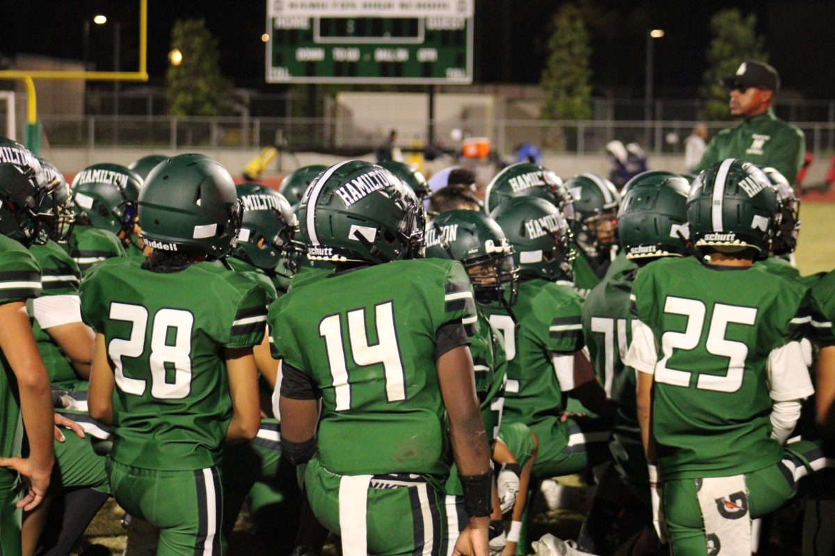 The team gathers for a postgame meeting on the sidelines.