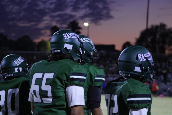 Football players wait for the sun to set in order to start the game.