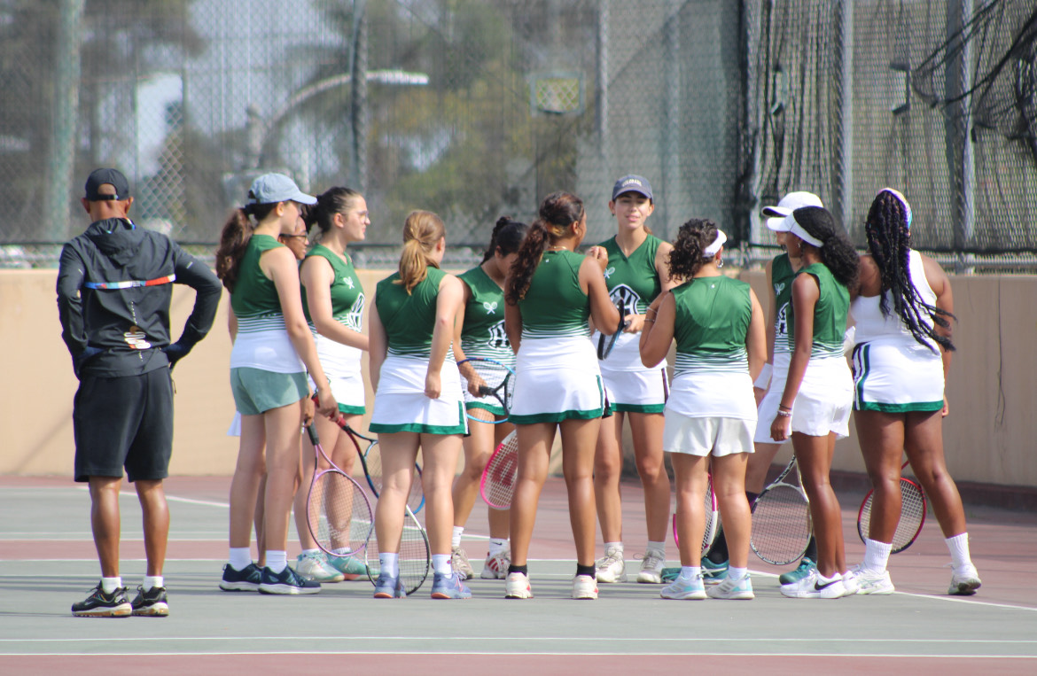 Hamilton's girls' tennis team huddles up for warm-ups.