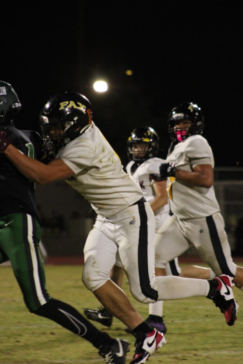 The opposing team Fairfax Lions initiates a tackle on the Hamilton Yankees. 