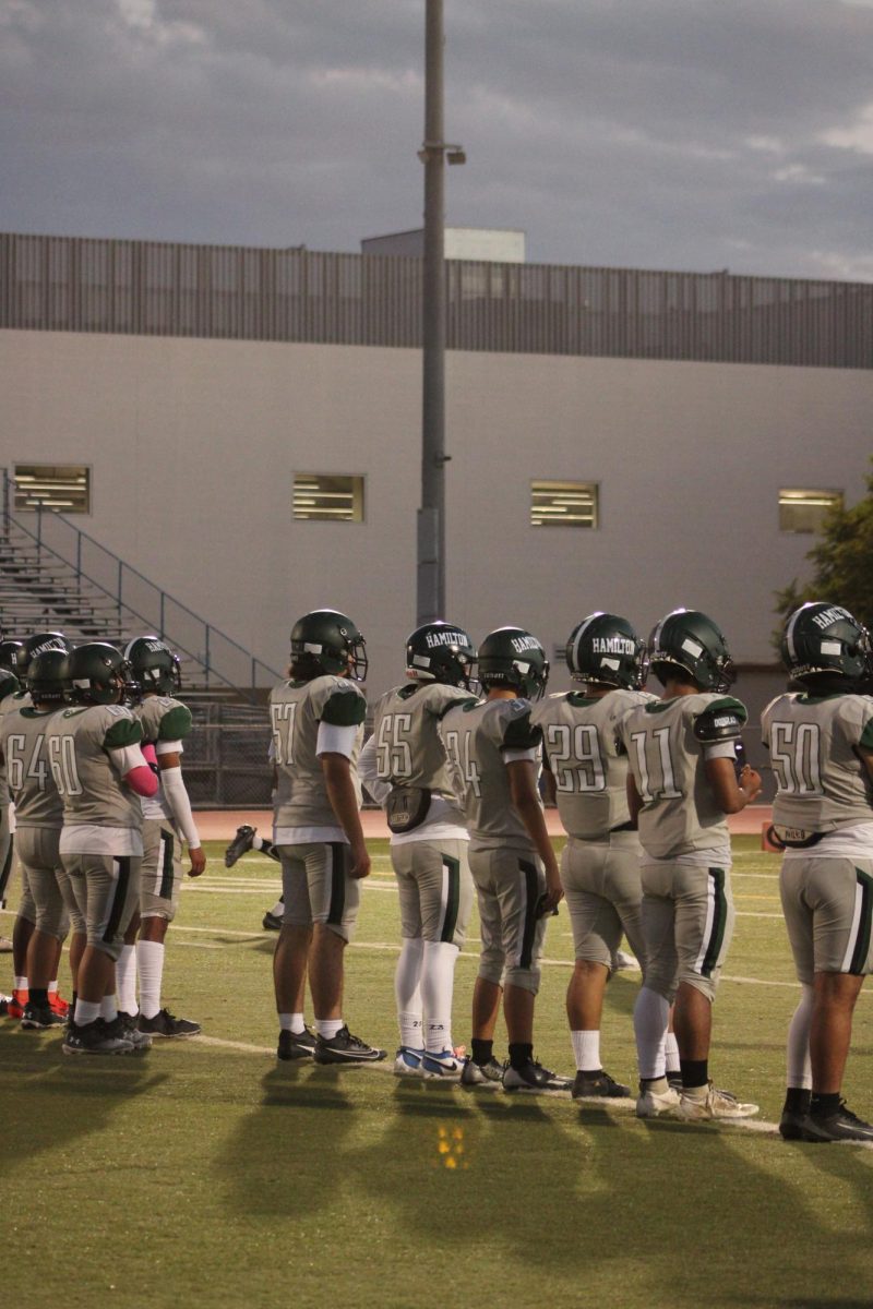 While waiting for the game to start, players wait for their turn to participate in the drills. 
