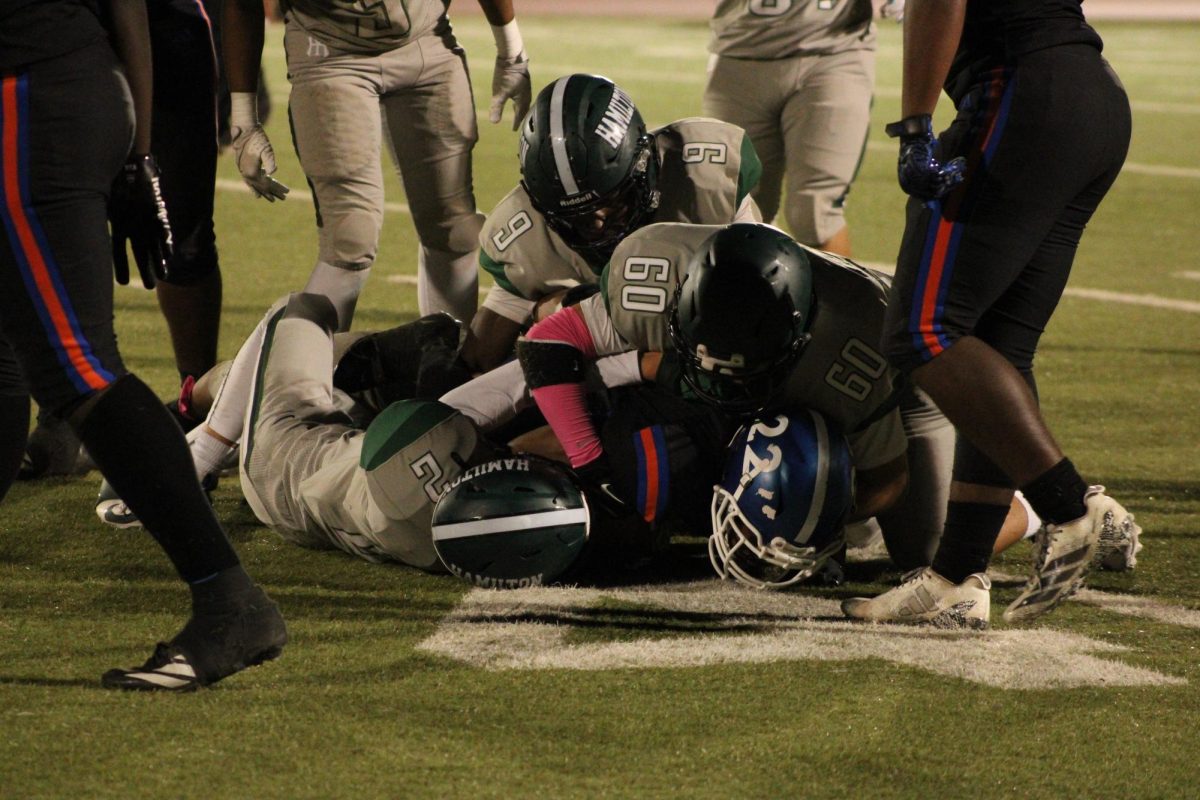 Hamilton players make a successful tackle on University in the third quarter. 