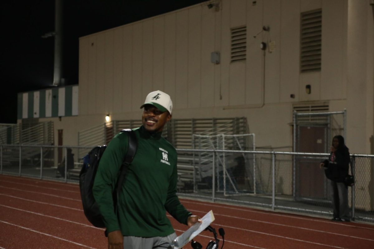 Coach Campbell walks back to the locker room after a successful game for his team. 