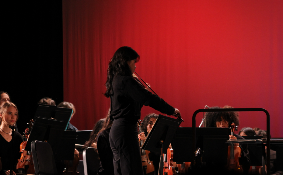 Violinist Tong Srlamba has a solo moment during the first act of the Collaborative Concert, performing with her orchestral counterparts. 