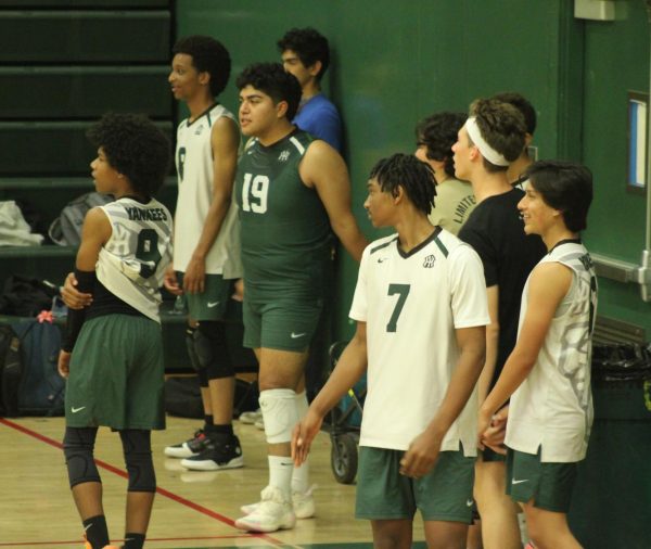 The varsity boys' volleyball team prepares for their game versus Westchester, which they won 3-0.