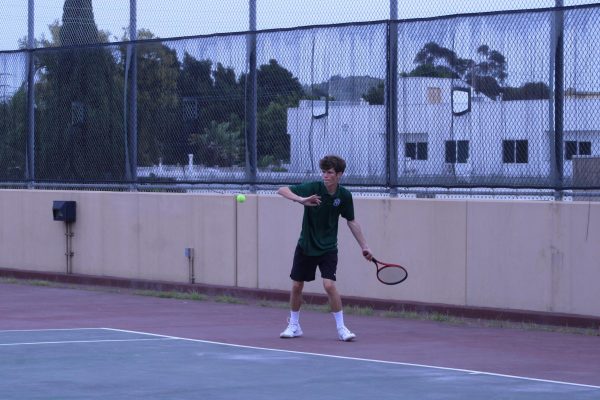Remy Doucette returns his opponent's serve fiercely. 