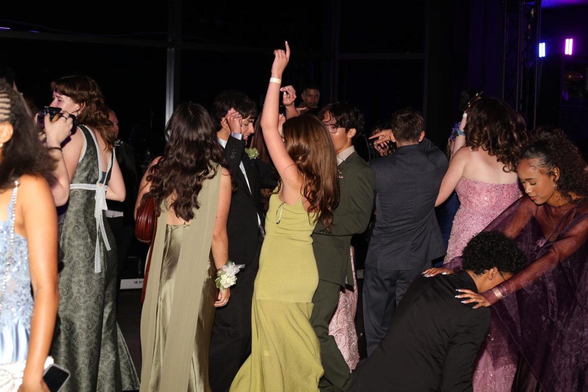 Seniors shown on the dance floor throughout the night, having fun with their friends. 