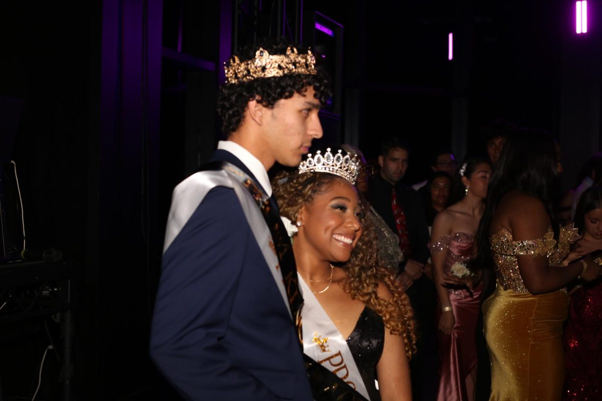 Autumn Hawkins and Mateo Arce pose for a photo as prom king and queen. 