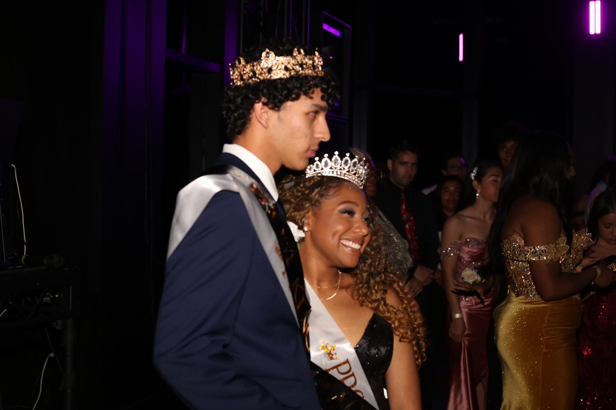Autumn Hawkins and Mateo Arce pose for a photo as prom king and queen. 